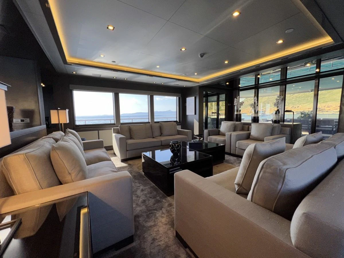 The salon features plush seating and expansive windows, offering a luxurious and comfortable space with stunning views. aboard SMOOTH OPERATOR Yacht for Sale
