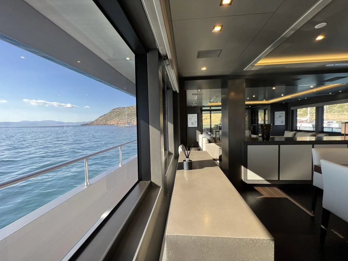 The yacht's interior offers a modern and spacious setting with large windows providing stunning sea views. aboard SMOOTH OPERATOR Yacht for Sale