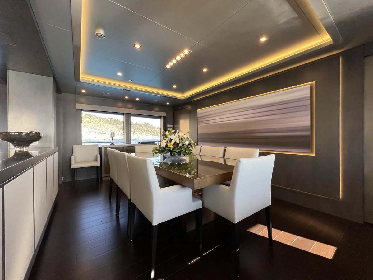 The yacht's dining area features a sleek, modern design with elegant furnishings and ambient lighting. aboard SMOOTH OPERATOR Yacht for Sale