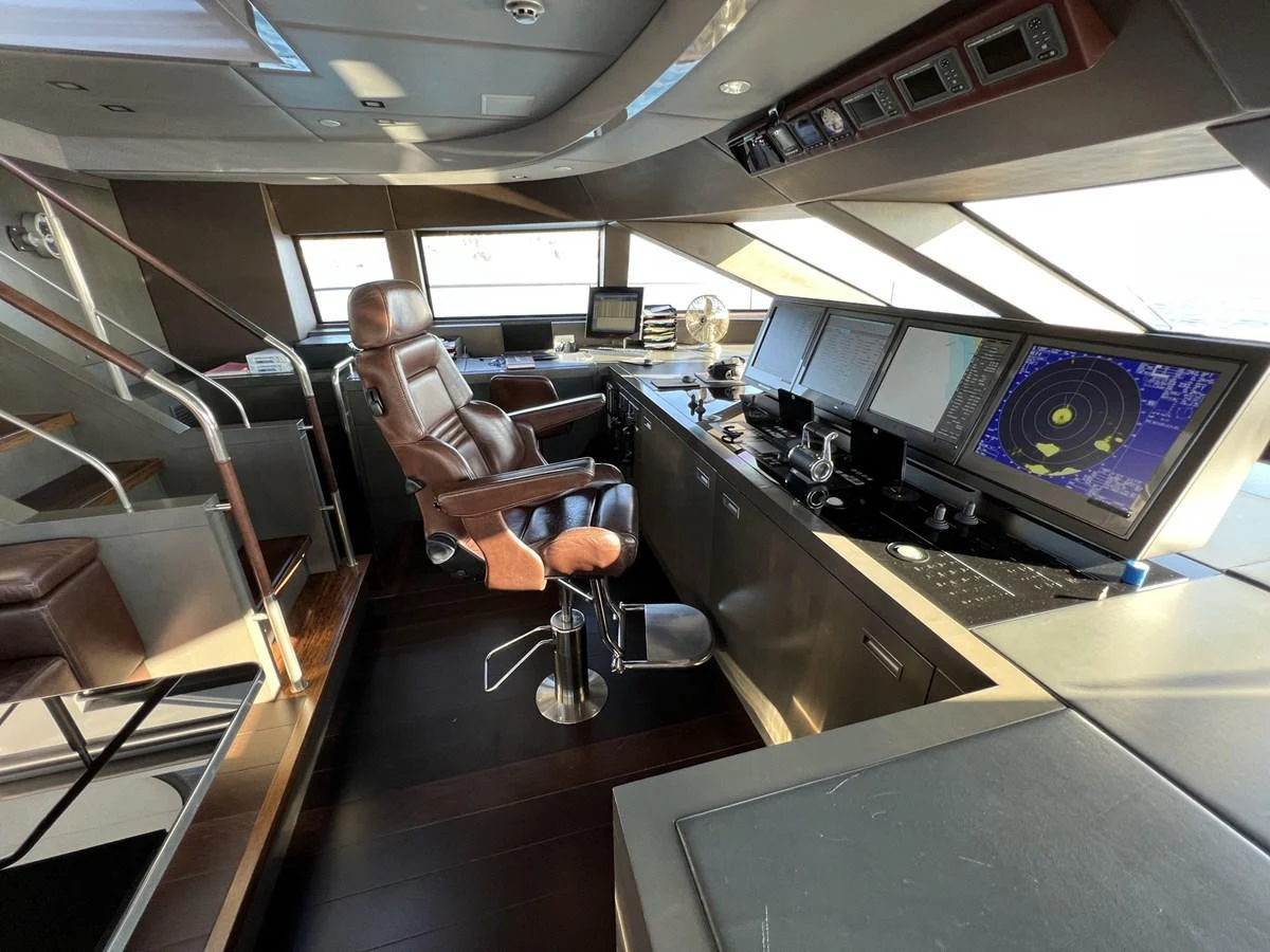 The helm station features advanced navigation equipment and a luxurious captain's chair. aboard SMOOTH OPERATOR Yacht for Sale