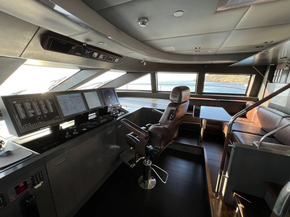 The helm station features advanced navigation equipment and a luxurious captain's chair, offering a commanding view of the sea. aboard SMOOTH OPERATOR Yacht for Sale