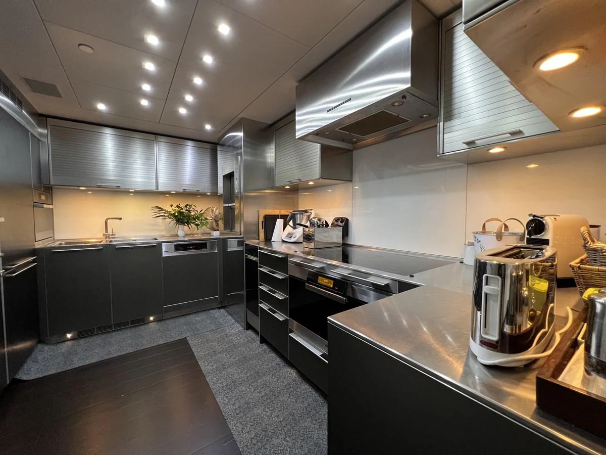 The modern galley features sleek stainless steel appliances and ample counter space. aboard SMOOTH OPERATOR Yacht for Sale