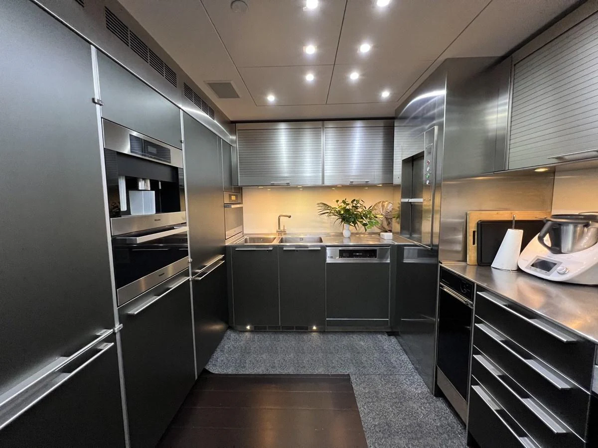 The modern galley features sleek stainless steel appliances and ample counter space. aboard SMOOTH OPERATOR Yacht for Sale
