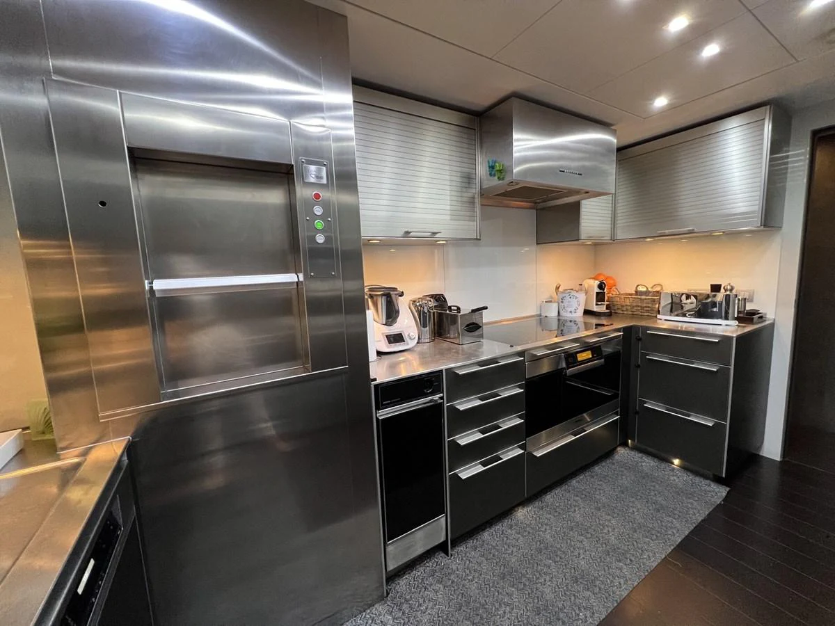 The yacht's galley features sleek stainless steel appliances and ample counter space for gourmet meal preparation. aboard SMOOTH OPERATOR Yacht for Sale