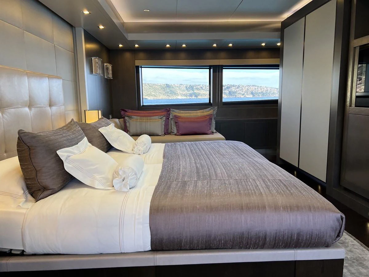 The master stateroom features a luxurious bed with elegant linens and large windows offering stunning views. aboard SMOOTH OPERATOR Yacht for Sale