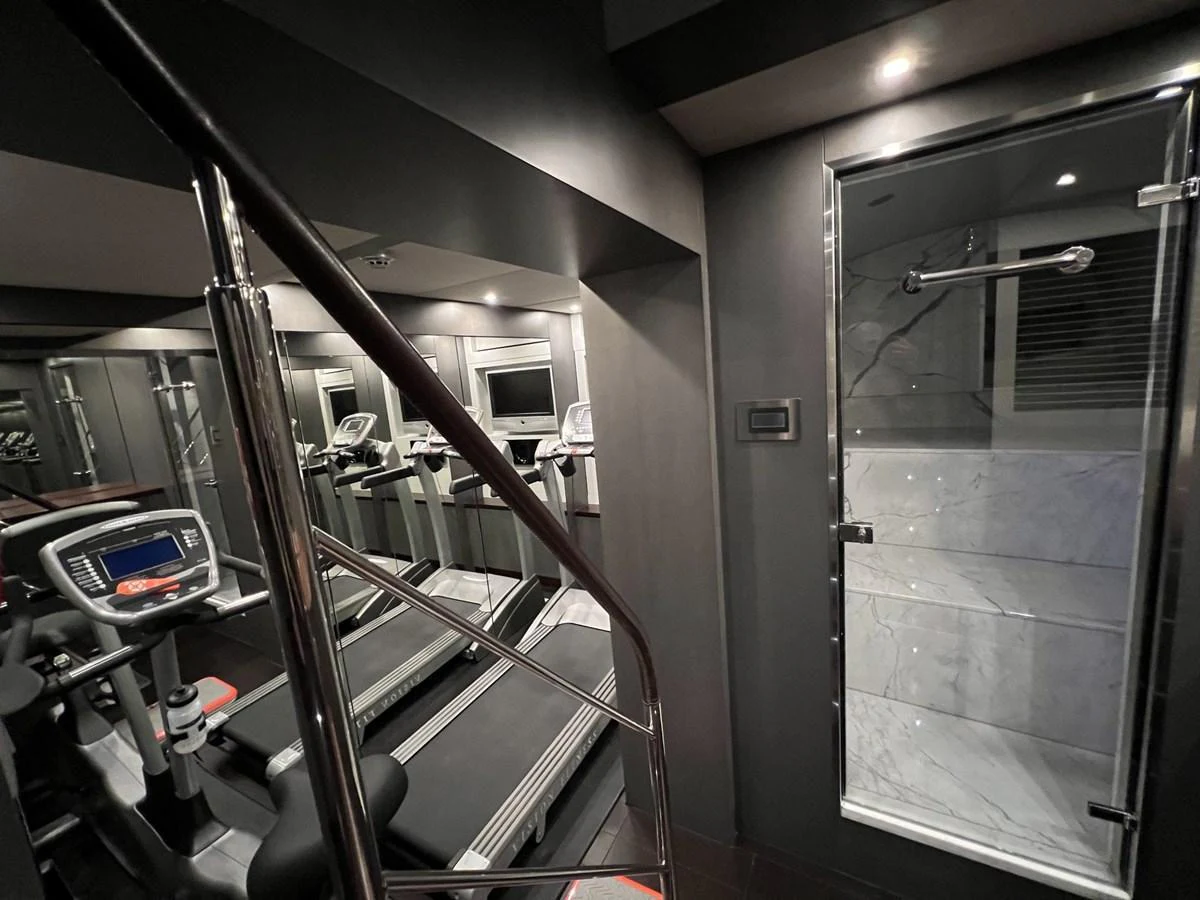 The yacht features a well-equipped gym with modern fitness equipment and a sleek design. aboard SMOOTH OPERATOR Yacht for Sale