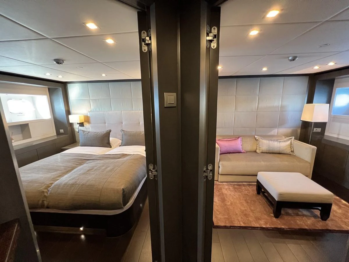 The master stateroom features a luxurious bed and a comfortable seating area, creating a serene retreat. aboard SMOOTH OPERATOR Yacht for Sale