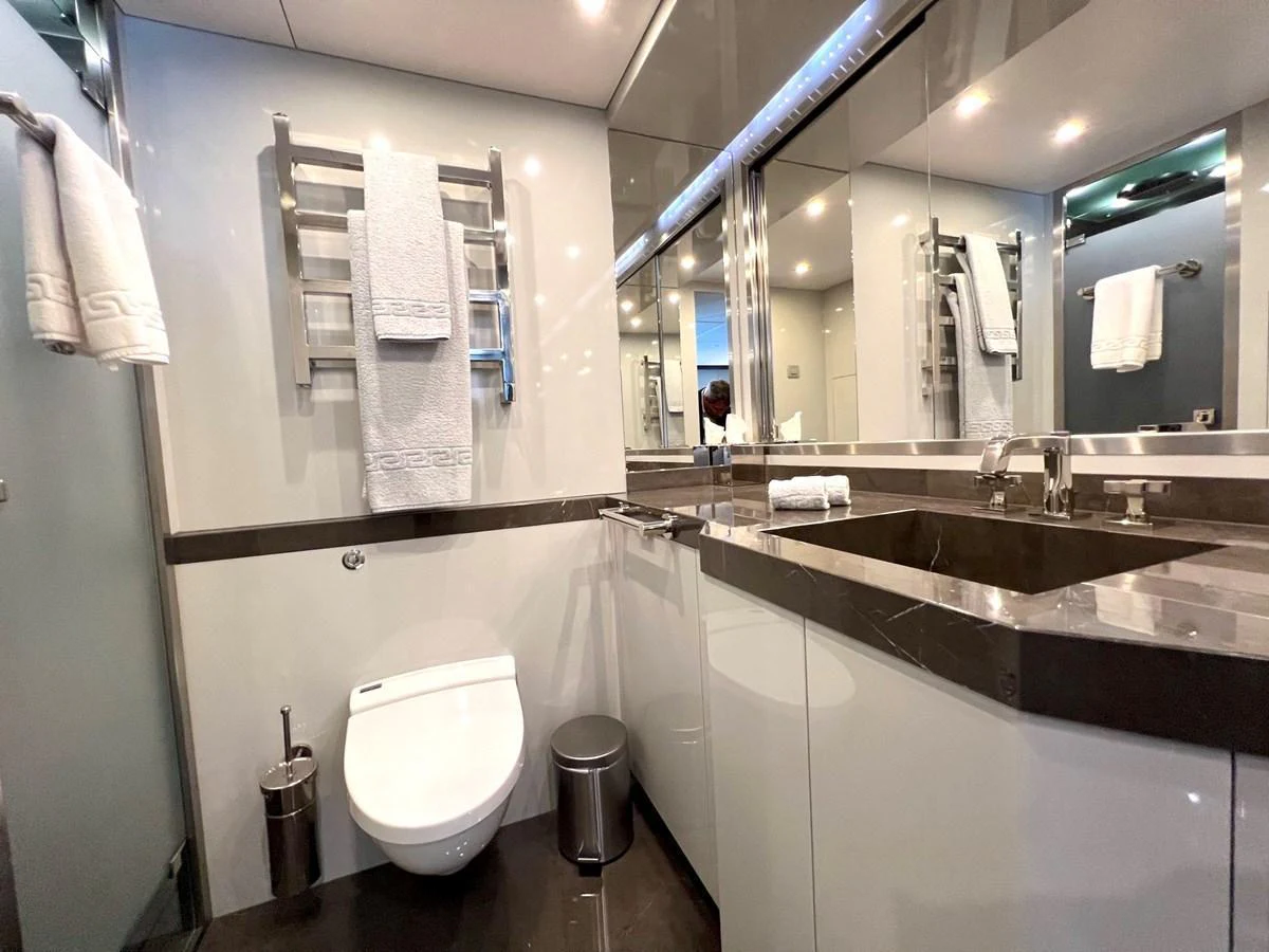 The yacht's bathroom features modern fixtures and a sleek design with ample mirrors and lighting. aboard SMOOTH OPERATOR Yacht for Sale