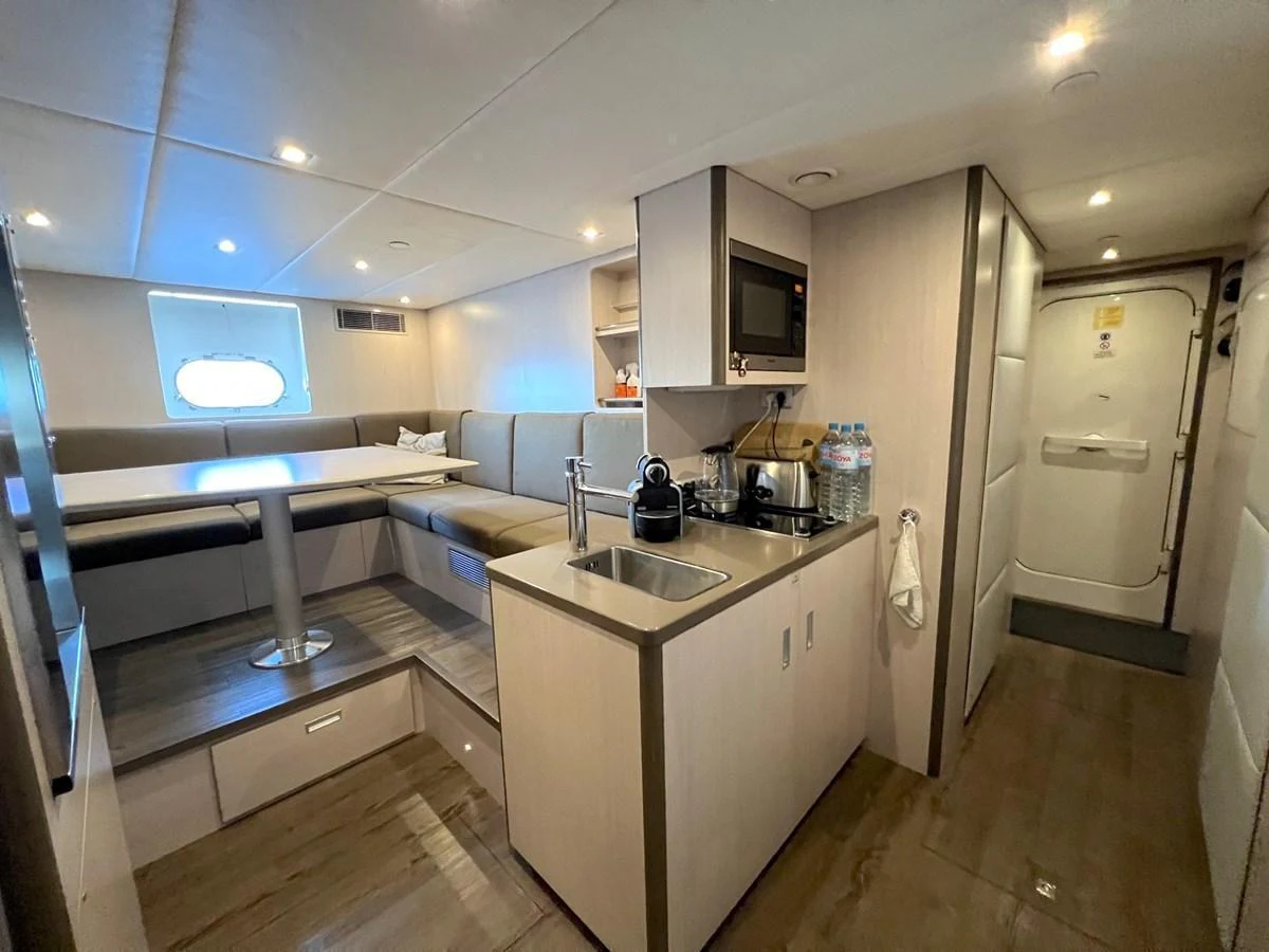 The yacht's galley features a cozy dining area and modern amenities for a comfortable onboard experience. aboard SMOOTH OPERATOR Yacht for Sale
