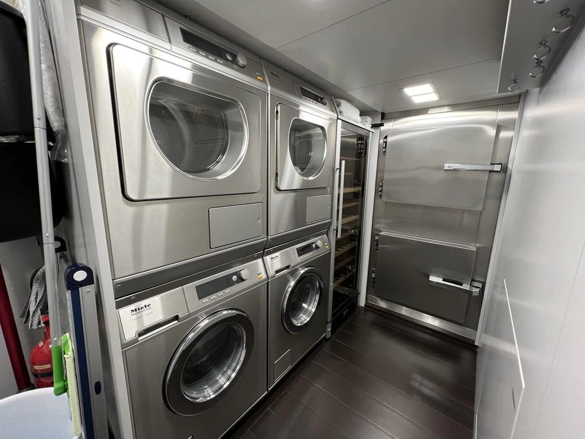 The yacht features a well-equipped laundry room with modern appliances. aboard SMOOTH OPERATOR Yacht for Sale
