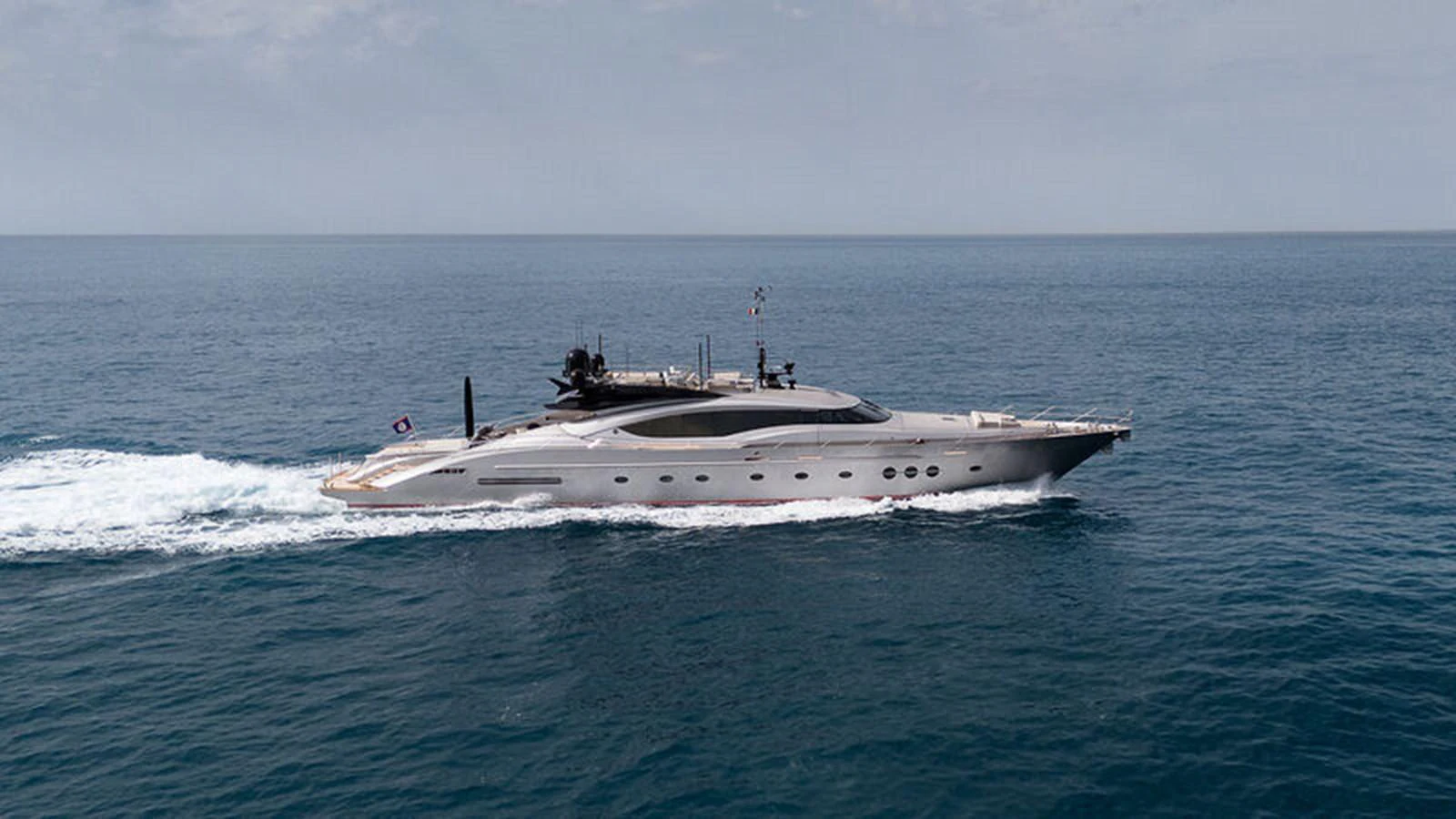 A sleek and modern yacht cruising on open waters under a clear sky. aboard BAGHEERA Yacht for Sale