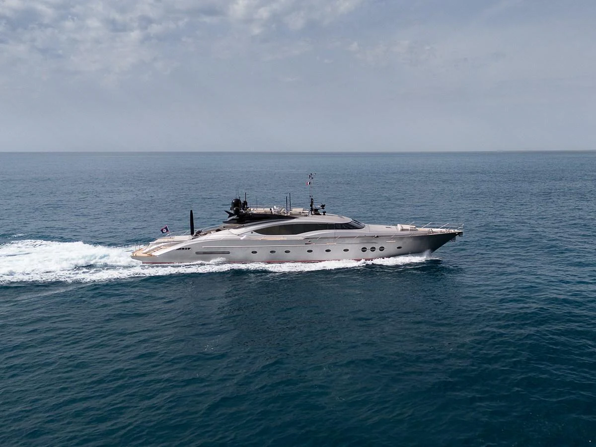 A sleek, modern yacht cruises swiftly across calm waters under a partly cloudy sky. aboard BAGHEERA Yacht for Sale