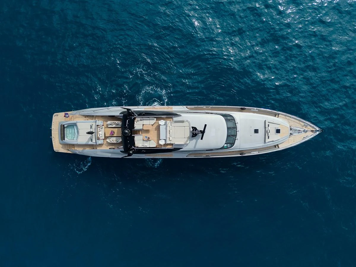 A sleek and elegant yacht cruising through clear blue waters, viewed from above. aboard BAGHEERA Yacht for Sale