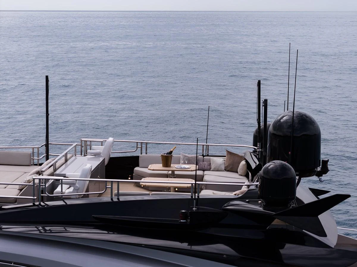 The aft deck of the yacht features a luxurious lounging area with a stunning ocean backdrop. aboard BAGHEERA Yacht for Sale