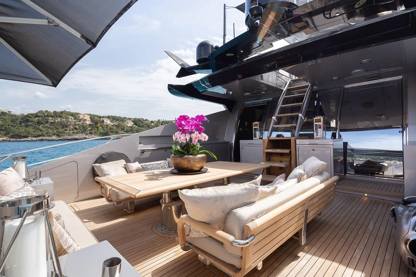The aft deck features a luxurious seating area with a table, perfect for outdoor relaxation and dining. aboard BAGHEERA Yacht for Sale