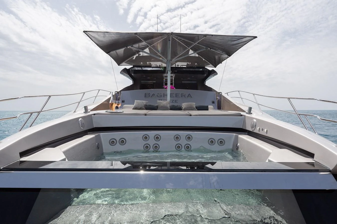 The yacht features a luxurious aft deck with a spacious jacuzzi and comfortable seating area. aboard BAGHEERA Yacht for Sale