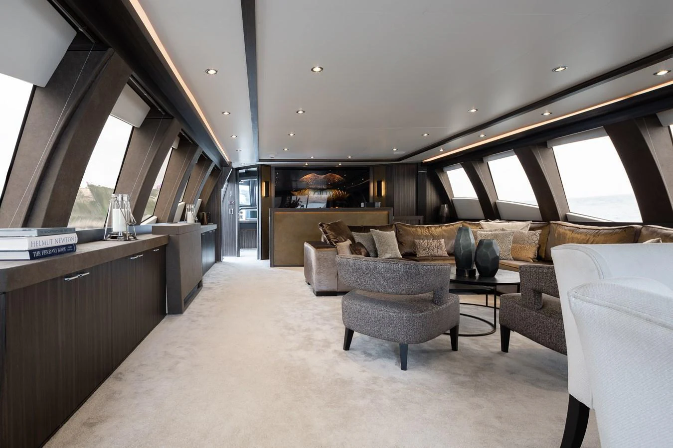 The yacht's salon features luxurious seating and ample natural light through large windows. aboard BAGHEERA Yacht for Sale