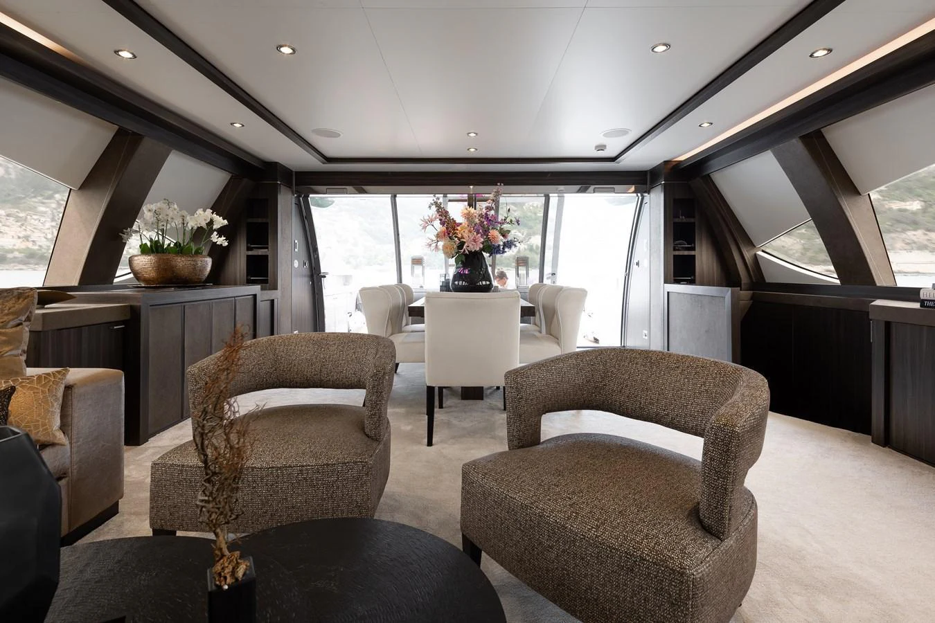 The yacht's interior features a spacious and elegantly furnished lounge area with large windows providing scenic views. aboard BAGHEERA Yacht for Sale