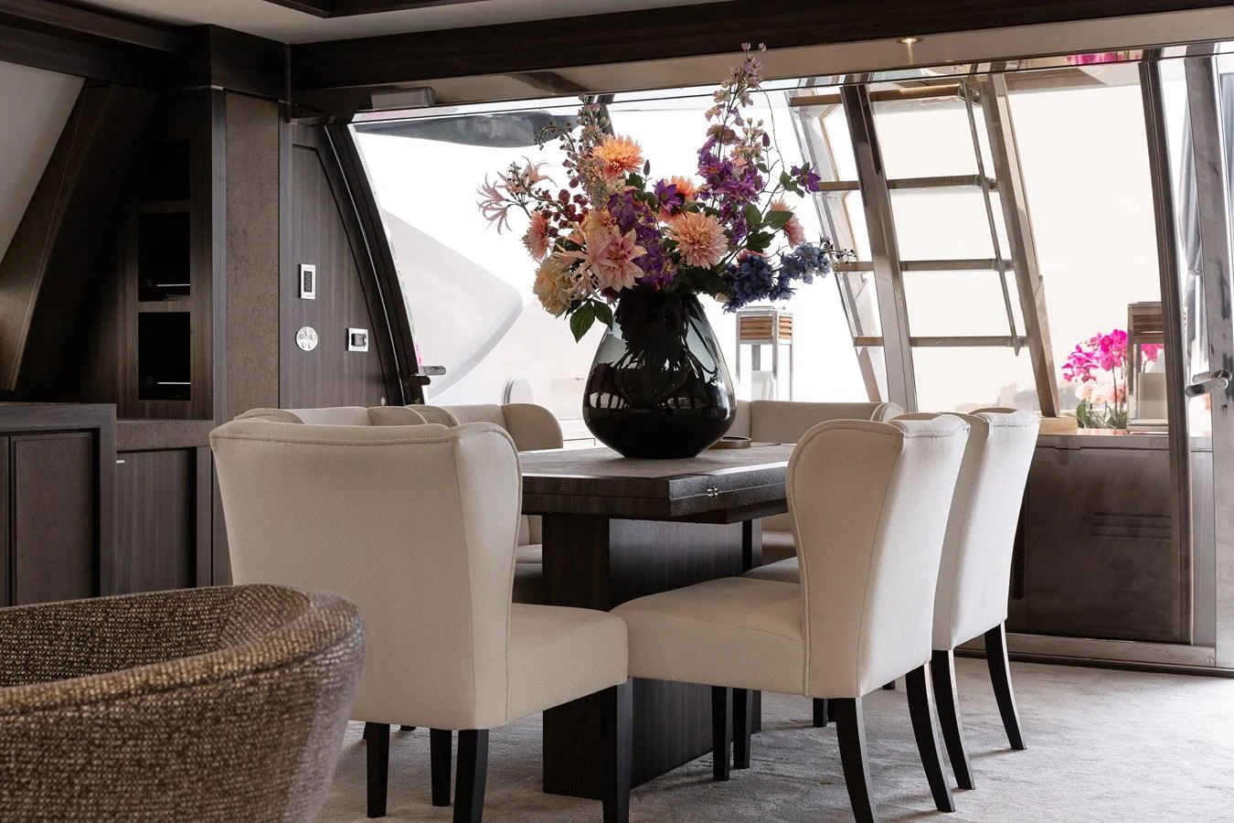 The yacht's dining area features elegant seating and a beautiful floral centerpiece, creating a luxurious and inviting atmosphere. aboard BAGHEERA Yacht for Sale