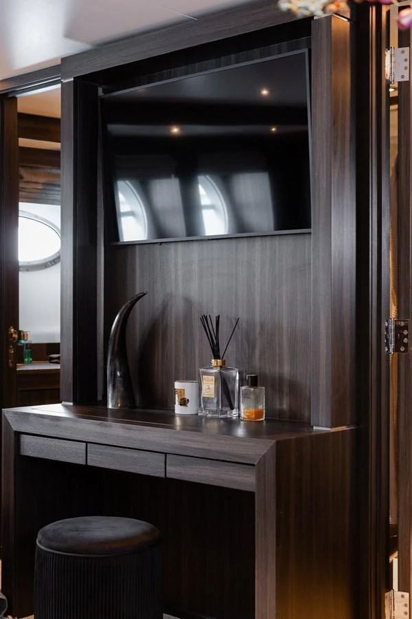 The yacht's interior features a sleek, modern entertainment area with a flat-screen TV and stylish decor. aboard BAGHEERA Yacht for Sale
