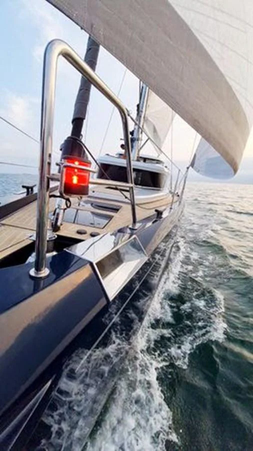 A sleek sailing yacht glides through the water with its sails fully deployed. aboard 2025 MCP GLOBAL EXP 68 Yacht for Sale