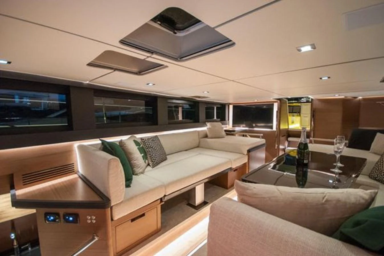 The yacht's salon features a spacious and elegantly designed seating area with modern furnishings and ambient lighting. aboard 2025 MCP GLOBAL EXP 68 Yacht for Sale