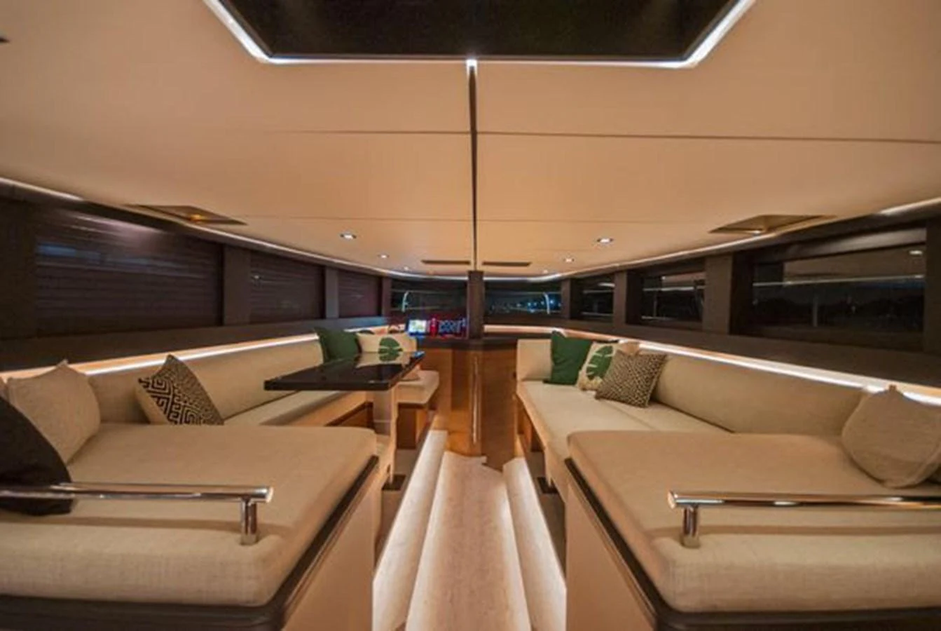 The yacht's interior features a spacious and elegantly designed seating area with plush cushions and ambient lighting. aboard 2025 MCP GLOBAL EXP 68 Yacht for Sale