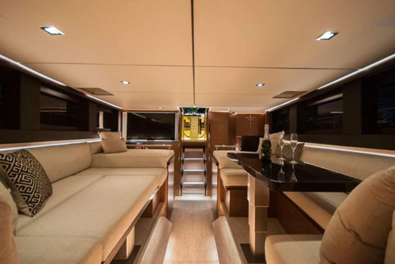 The yacht's interior features a spacious and elegantly designed seating area with modern lighting. aboard 2025 MCP GLOBAL EXP 68 Yacht for Sale