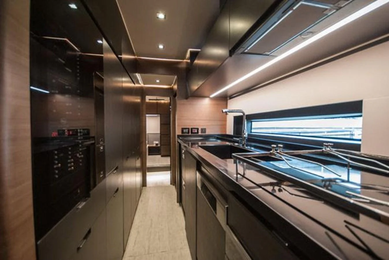 The sleek and modern galley is equipped with high-end appliances and ample counter space. aboard 2025 MCP GLOBAL EXP 68 Yacht for Sale