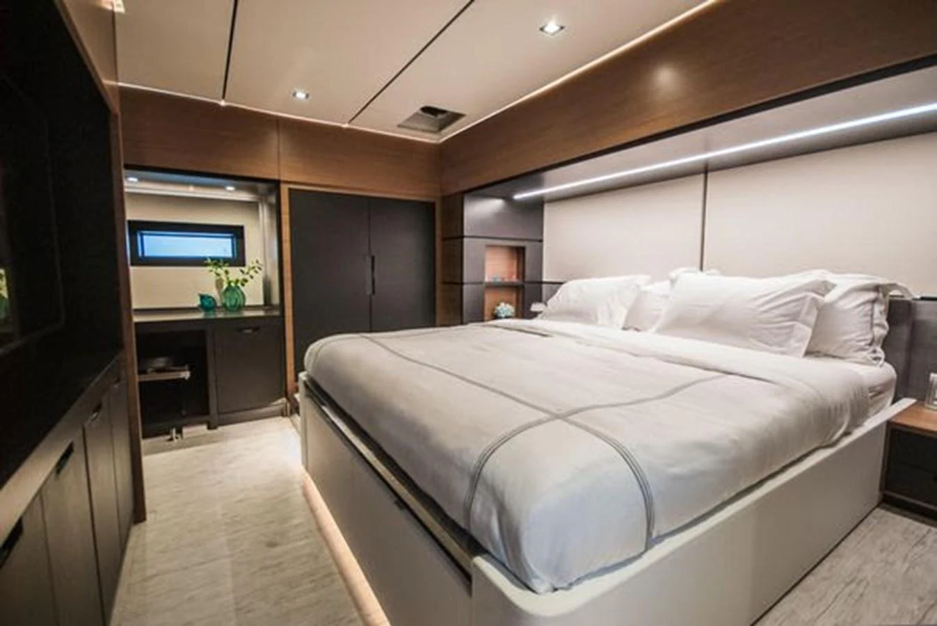 The master stateroom features a spacious bed with elegant lighting and modern decor. aboard 2025 MCP GLOBAL EXP 68 Yacht for Sale