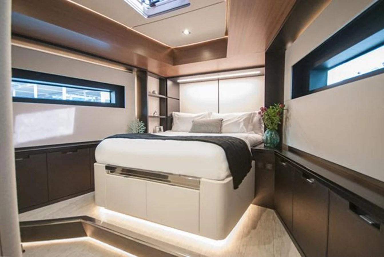 The stateroom features a luxurious bed with modern lighting and sleek cabinetry. aboard 2025 MCP GLOBAL EXP 68 Yacht for Sale