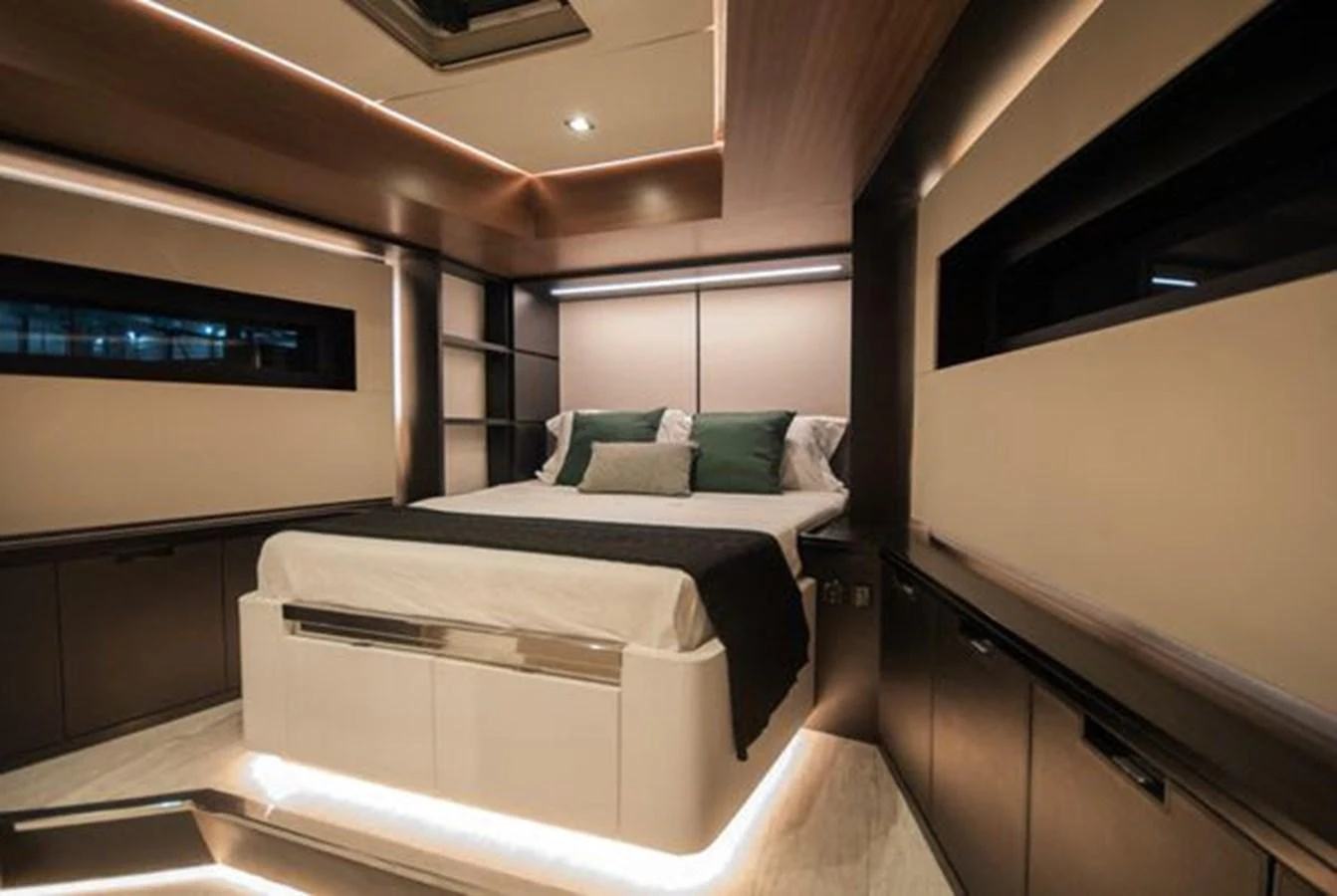 A luxurious stateroom featuring a large bed with ambient lighting and modern design elements. aboard 2025 MCP GLOBAL EXP 68 Yacht for Sale