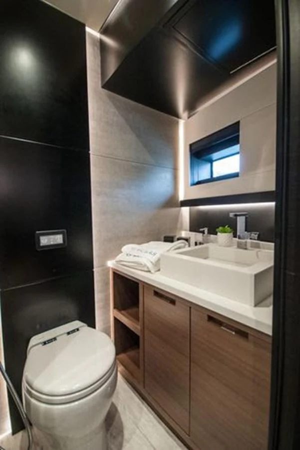 A modern yacht bathroom featuring sleek fixtures and contemporary design. aboard 2025 MCP GLOBAL EXP 68 Yacht for Sale