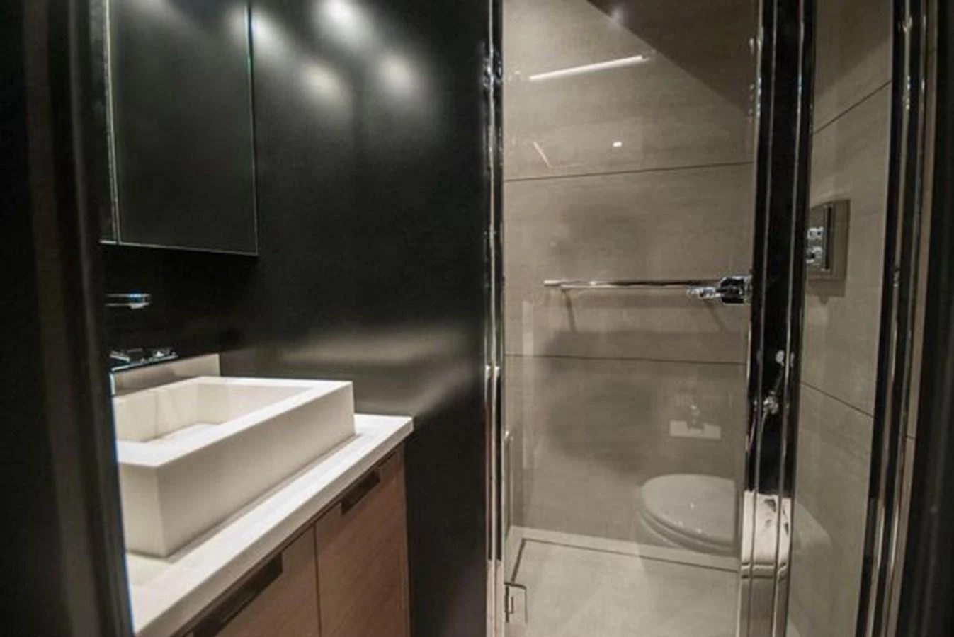 A sleek and modern bathroom with a glass-enclosed shower and a stylish sink. aboard 2025 MCP GLOBAL EXP 68 Yacht for Sale