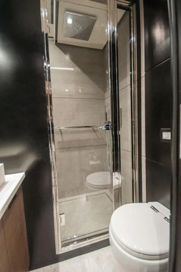 A sleek and modern yacht bathroom with a glass-enclosed shower and contemporary fixtures. aboard 2025 MCP GLOBAL EXP 68 Yacht for Sale