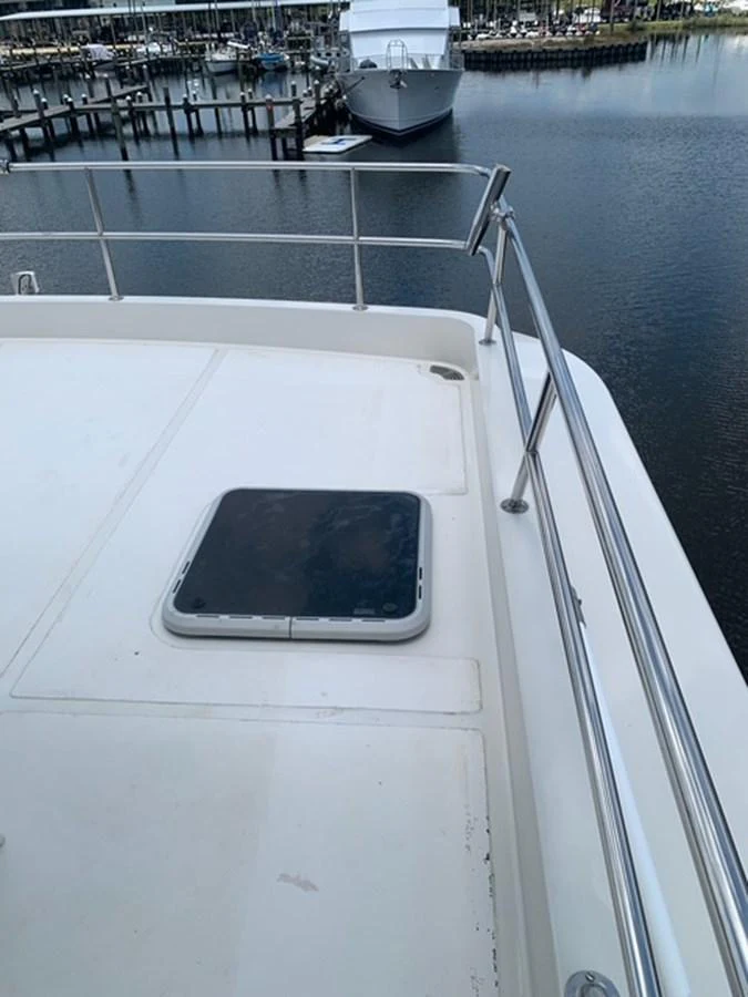 A close-up view of a yacht's deck area featuring a hatch and railing. aboard THE CAT FROM THE HAT Yacht for Sale