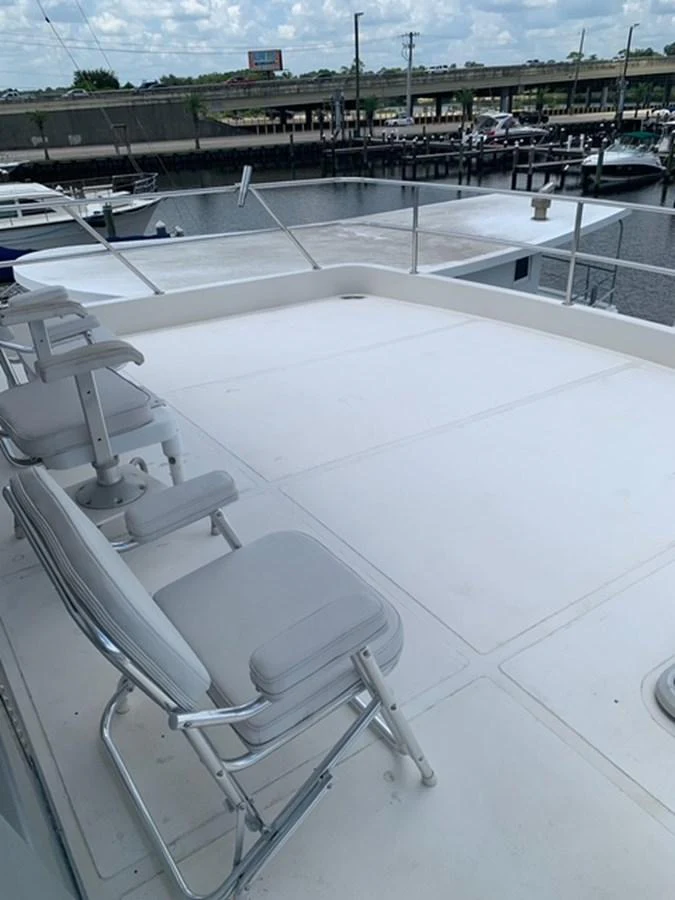 The flybridge offers a spacious and open area with seating, perfect for enjoying the view. aboard THE CAT FROM THE HAT Yacht for Sale