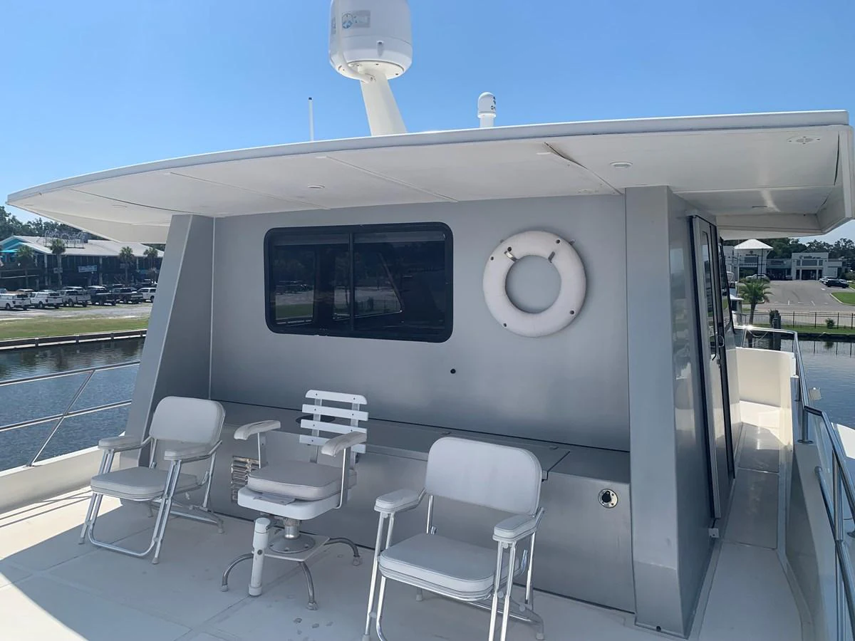 The aft deck features comfortable seating and a clean, modern design. aboard THE CAT FROM THE HAT Yacht for Sale