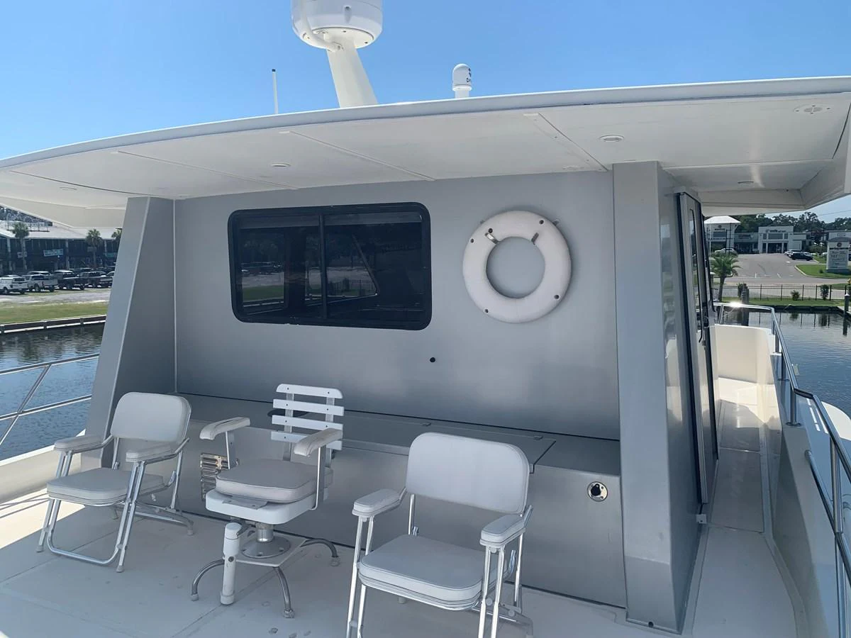 The flybridge features comfortable seating and a life ring for safety. aboard THE CAT FROM THE HAT Yacht for Sale