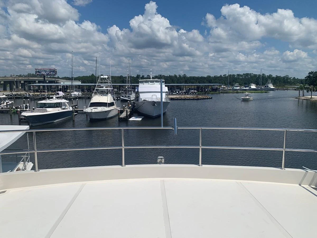 The yacht's aft deck offers a serene view of the marina, perfect for relaxation and enjoying the surroundings. aboard THE CAT FROM THE HAT Yacht for Sale