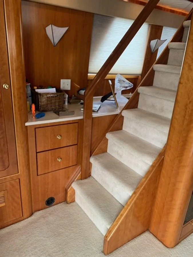A cozy interior staircase with wooden accents and carpeted steps. aboard THE CAT FROM THE HAT Yacht for Sale