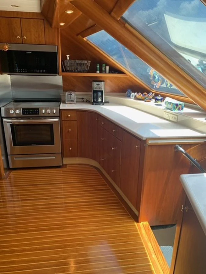 The yacht's galley features modern appliances and ample natural light through large windows. aboard THE CAT FROM THE HAT Yacht for Sale