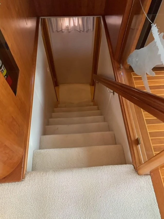A cozy, carpeted staircase leads to the lower deck of the yacht. aboard THE CAT FROM THE HAT Yacht for Sale