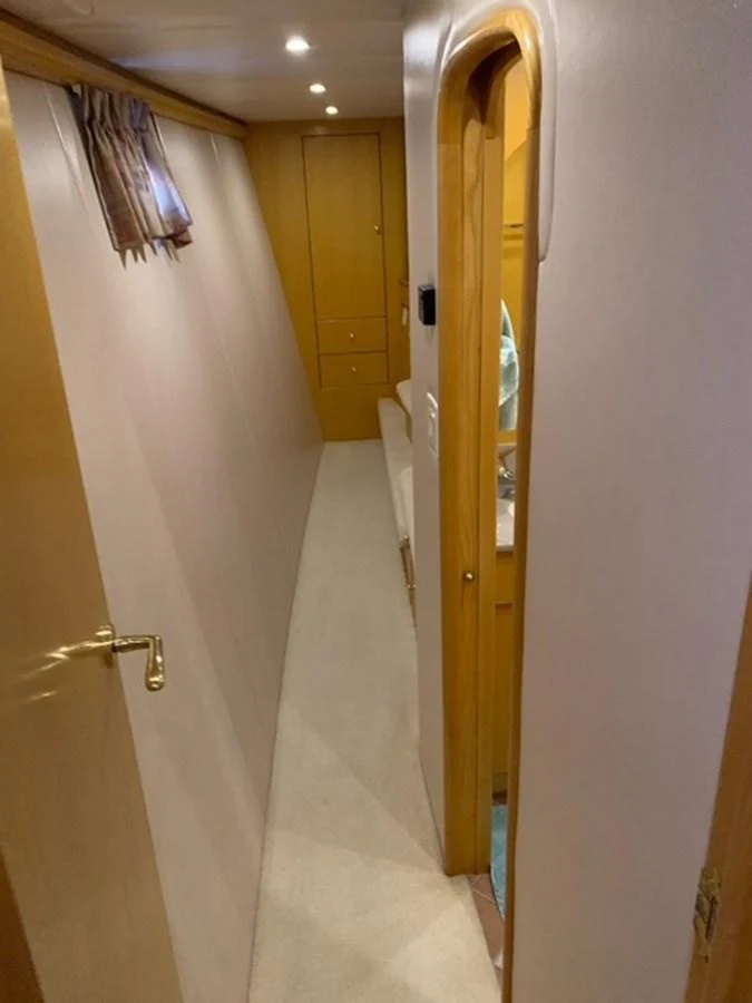 A cozy hallway with wooden accents and soft lighting. aboard THE CAT FROM THE HAT Yacht for Sale