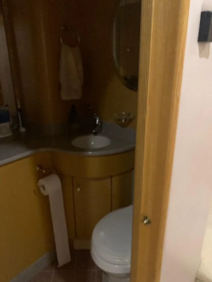 A compact yacht bathroom with essential amenities. aboard THE CAT FROM THE HAT Yacht for Sale