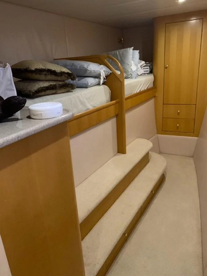 A cozy cabin with a bunk bed and storage space, perfect for a comfortable stay. aboard THE CAT FROM THE HAT Yacht for Sale
