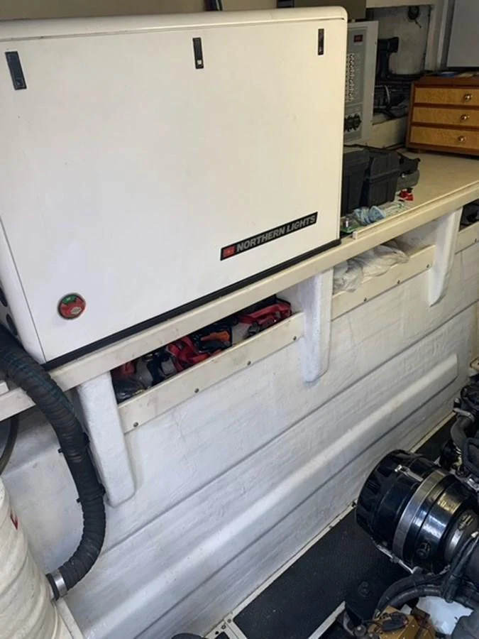 The image shows the engine room of the yacht, featuring a Northern Lights generator and various mechanical components. aboard THE CAT FROM THE HAT Yacht for Sale