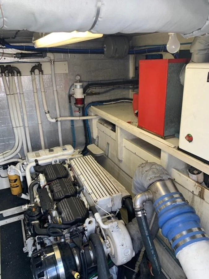 The image shows the yacht's engine room with visible machinery and piping. aboard THE CAT FROM THE HAT Yacht for Sale
