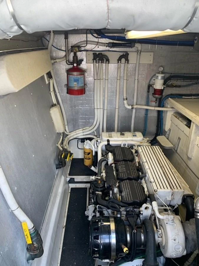 The image showcases the yacht's well-maintained engine room with visible machinery and piping. aboard THE CAT FROM THE HAT Yacht for Sale