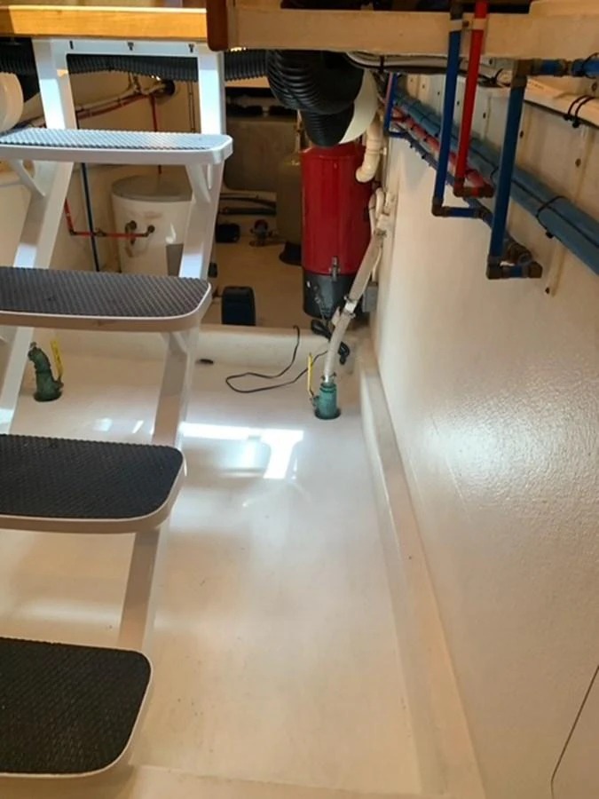 The image showcases a section of the yacht's engine room with visible stairs and various equipment. aboard THE CAT FROM THE HAT Yacht for Sale